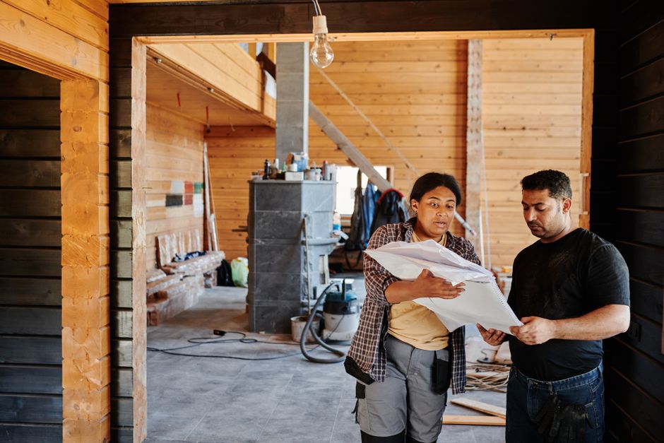 Kitchen renovation team reviewing plans in a partially finished space